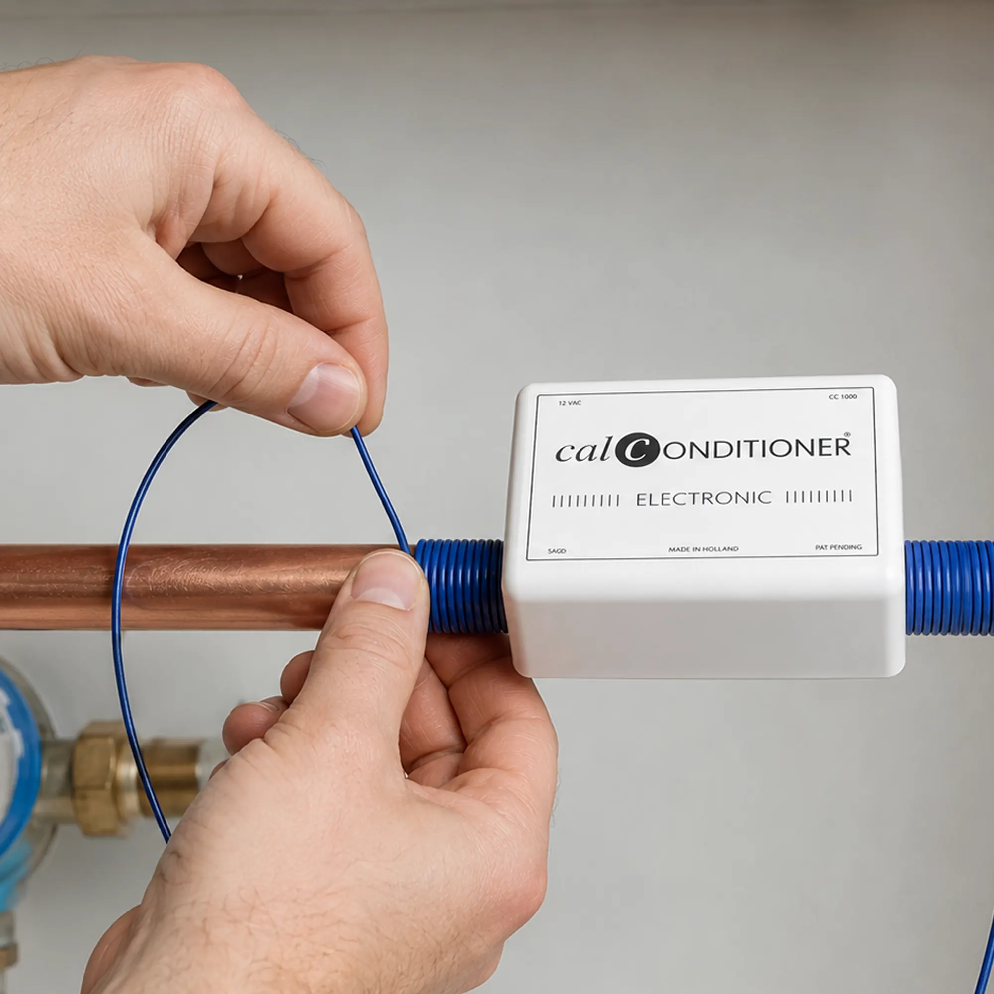 Wrapping the Calconditioner’s blue coil cable around a water pipe